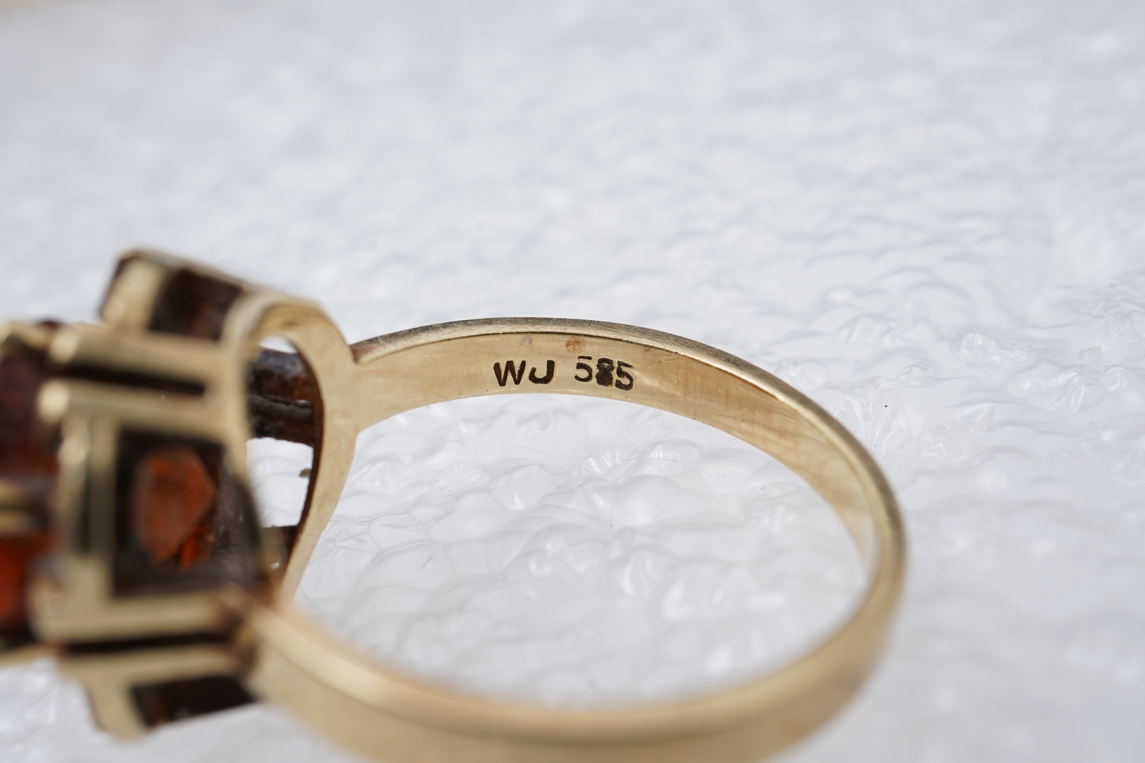 Two brooches and a ring, mid 20th century, comprising: a brooch of floral design, set with circular-cut synthetic gemstones, length 3.7cm, Austrian assay marks for gold, gross weight approximately 6.5 grams; a brooch des